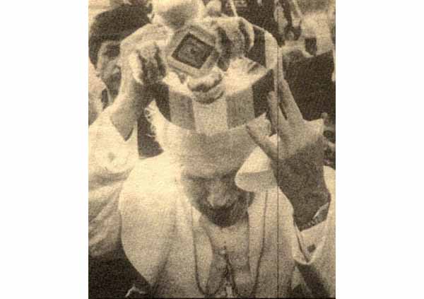 John Paul II putting on a clownish hat